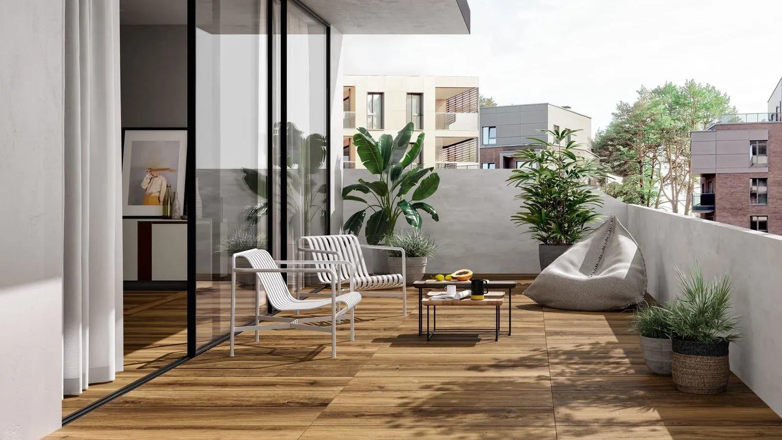 Modern apartment balcony terrace in Indore featuring wooden flooring, white outdoor chairs, a bean bag, and potted plants.