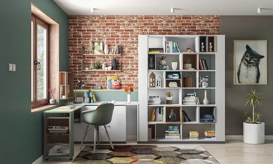 Modern home office interior in Indore featuring an exposed brick accent wall, white bookshelf, and study desk.